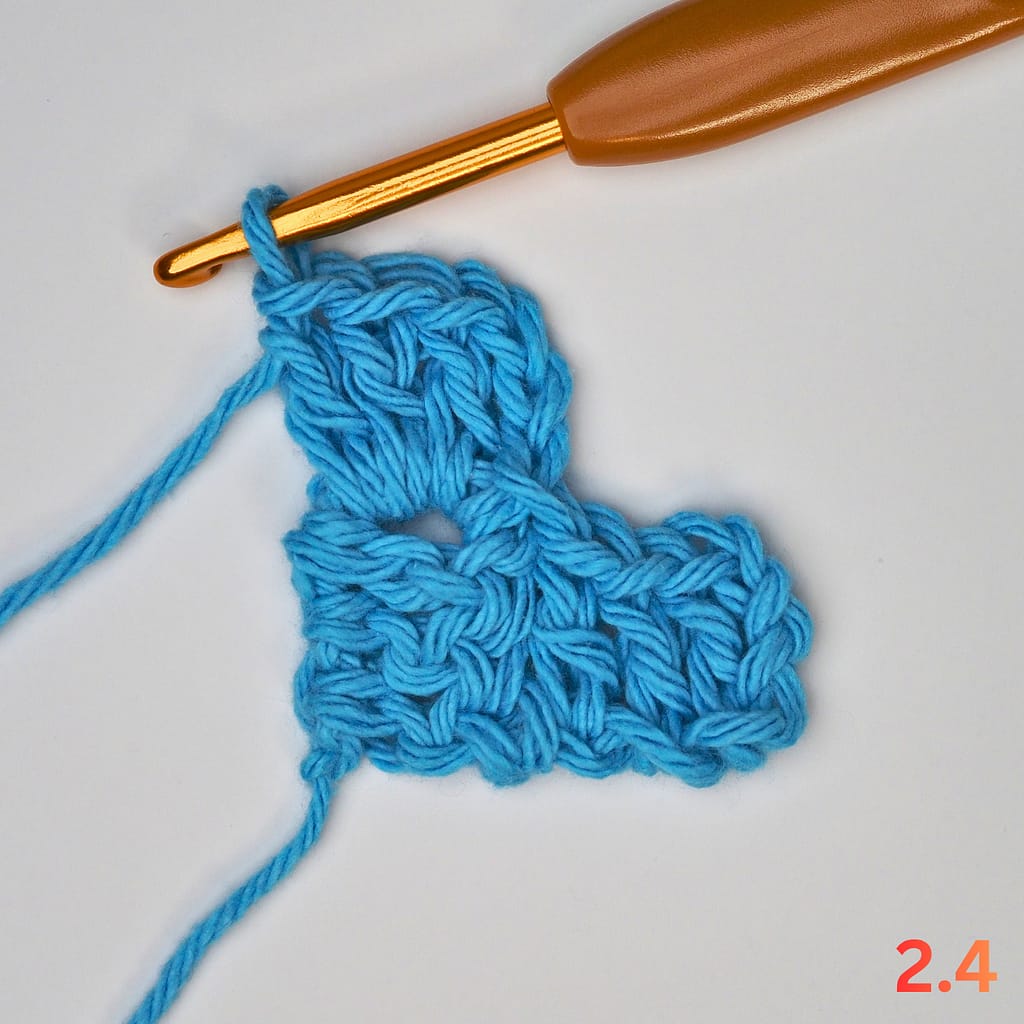 C2C Row 2 step 4: chain three and work three double crochets into the same space to complete two blocks.