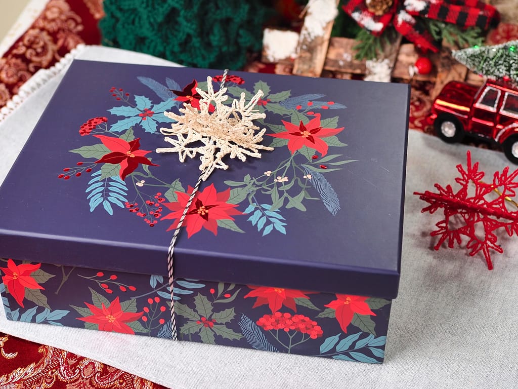 the gift box decorated with a 3D snowflake as a gift topper
