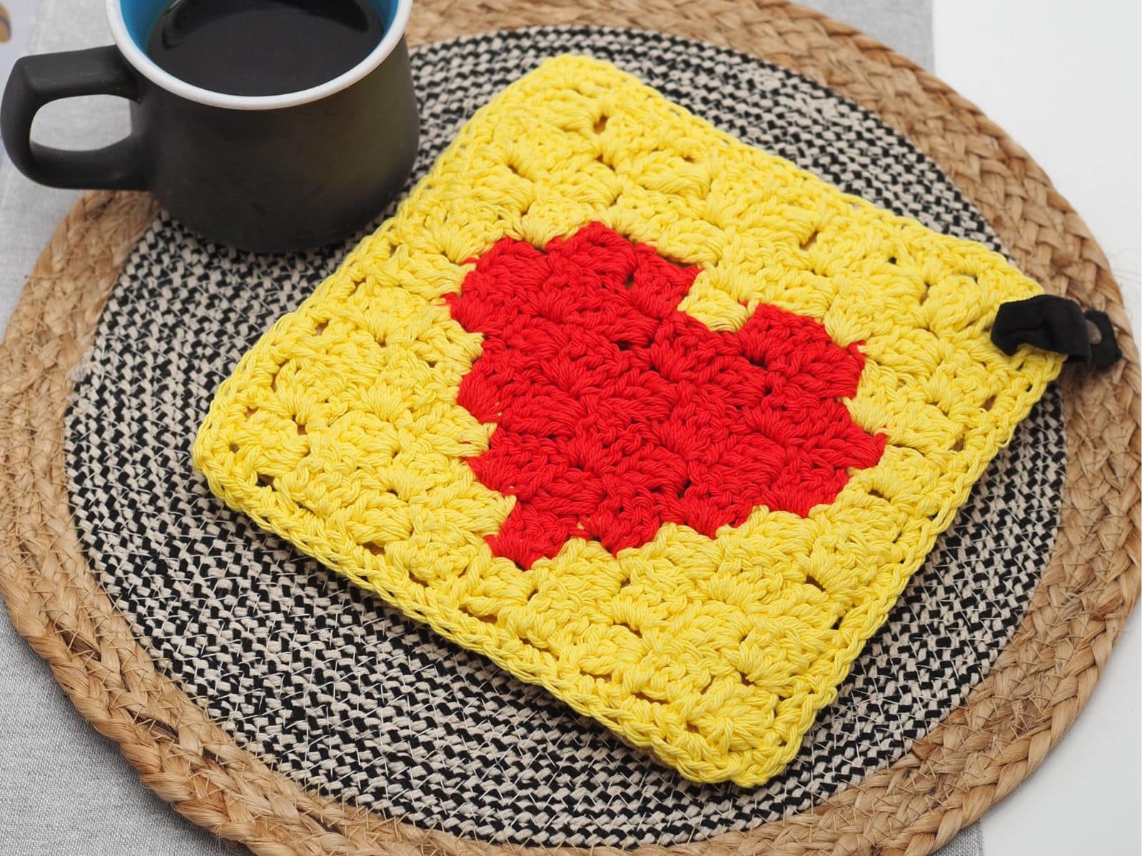 C2C heart crochet potholder with a red heart on a yellow background made using the corner-to-corner crochet technique.